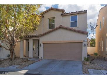 Charming two-story home featuring a two-car garage, neutral stucco, and manicured landscaping at 908 Shining Rose Pl, Henderson, NV 89052