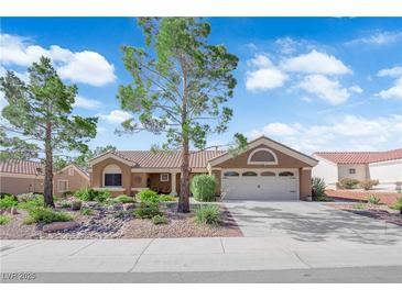 Charming single-story home featuring a tile roof, desert landscaping and a two-car garage at 9237 Quail Ridge Dr, Las Vegas, NV 89134