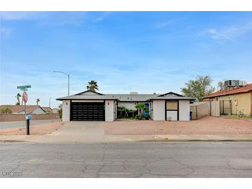 Charming single story house with a black garage door and low maintenance landscaping at , Henderson, NV 89015