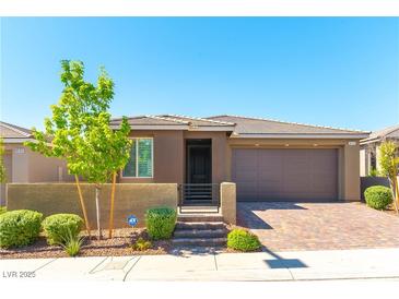 Charming single-story home featuring a low wall, front garden, and a two-car garage at 10711 Silver Pond Ave, Las Vegas, NV 89135