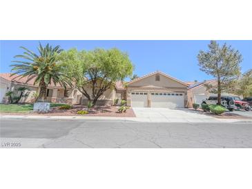 Charming single-story home featuring a three-car garage and mature landscaping at 1174 Monogram Way, Las Vegas, NV 89123