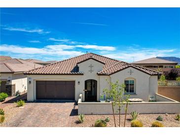 Charming single-story home featuring a tile roof, stucco exterior, and a well-maintained front yard at 129 Major Bowling Pl, Henderson, NV 89011
