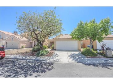 Charming single-story home with a two-car garage and mature landscaping at 1349 Goldenglow Rd, Las Vegas, NV 89108