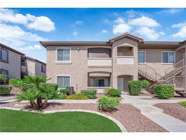 Inviting exterior with landscaped grounds, beige stucco, private balconies, and covered entryways, providing great curb appeal at 2305 W Horizon Ridge Pkwy # 611, Henderson, NV 89052
