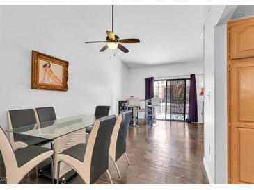 Bright dining room boasts a modern glass table, stylish chairs, and sleek hardwood flooring at 2851 S Valley View Blvd # 1120, Las Vegas, NV 89102