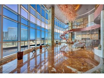 Luxury living room boasting a spiral staircase, floor-to-ceiling windows, and marble flooring for a sophisticated ambiance at 4525 Dean Martin Dr # 2503, Las Vegas, NV 89103