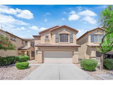 Charming two-story home featuring a two-car garage, manicured landscaping, and a welcoming front porch at 5653 Mount Athos St, North Las Vegas, NV 89031