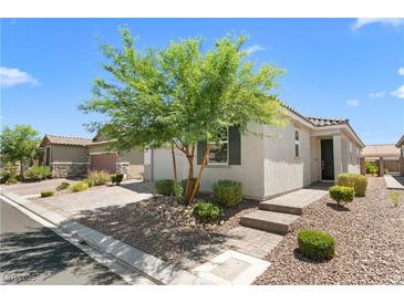 Charming single-story home featuring desert landscaping and a well-manicured front yard at 5936 Bruselas St, Las Vegas, NV 89113