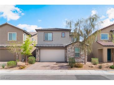 Charming two-story home featuring desert landscaping, stone accents and a brick paver driveway at 7132 Sayonara Vista St, North Las Vegas, NV 89084