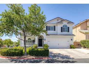 Charming two-story home with a well-manicured lawn and beautiful landscaping at 7849 Meandering Light Ave, Las Vegas, NV 89131