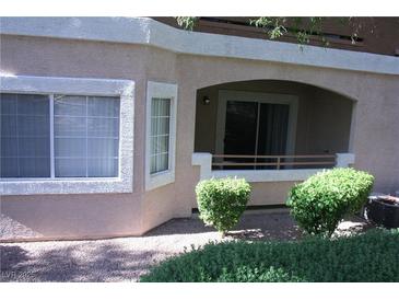 Charming condo featuring stucco siding, neutral color scheme, and a private patio with a sliding glass door and covered entry at 830 Carnegie St # 1011, Henderson, NV 89052