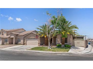 Charming single-Gathering home with mature landscaping, two-car garage, and an inviting entryway at 1310 Ripplestone Ave, North Las Vegas, NV 89081