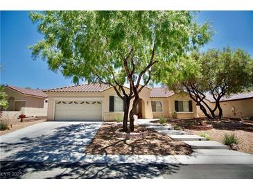 Charming single-story home featuring a well-maintained front yard and a two-car garage at 1830 Lake Wales St, Henderson, NV 89052