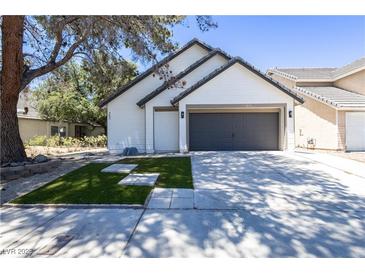 Charming single-Gathering home with a manicured front yard and a two-car garage on a sunny day at 363 El Pico Dr, Henderson, NV 89014