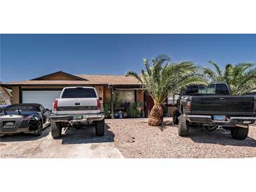 Cozy single-story home featuring mature landscaping and a gravel yard for low maintenance at 517 Longtree Ave, Henderson, NV 89011