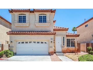 Charming two-story home with a white garage door and a red tile roof in a suburban neighborhood at 5282 Monterey Park Cir, Las Vegas, NV 89146