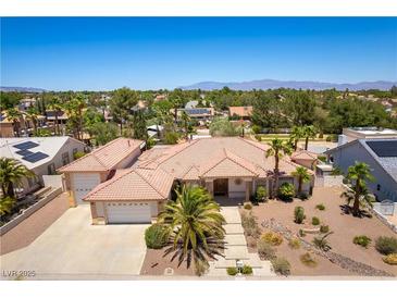 Stunning single-story home featuring a tile roof, desert landscaping, and a three-car garage at 7250 Birkland Ct, Las Vegas, NV 89117
