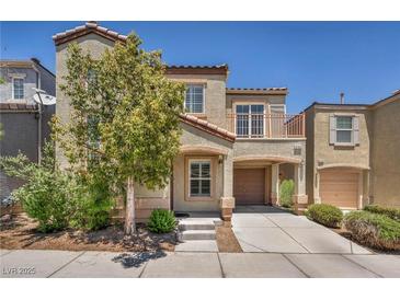 Charming two-story home featuring a balcony, covered parking, and a well-maintained front yard at 9104 Pearl Cotton Ave, Las Vegas, NV 89149