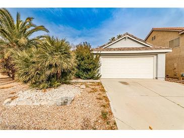 Charming single-story home with well-maintained landscaping and attached two-car garage at 9514 Teton Vista Ave, Las Vegas, NV 89117