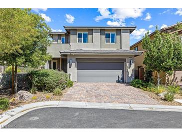 Charming two-story home featuring manicured landscaping, brick driveway, and a gray two-car garage at 7017 Pearl Hilltop Ct, Las Vegas, NV 89148