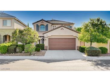Charming two-story home featuring a two-car garage and manicured landscaping at 1013 Brinkman St, Las Vegas, NV 89138