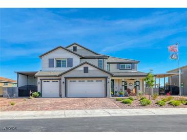 Beautiful two-story home with a three-car garage, covered car port and a charming front porch at 1523 Great Sands St, Boulder City, NV 89005