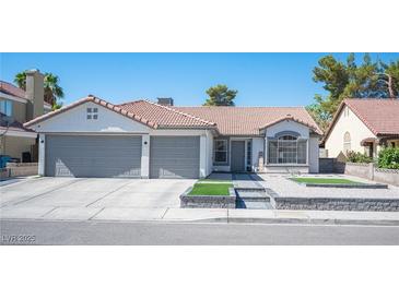 Charming single-story home featuring a tile roof, a two-car garage, and low-maintenance landscaping at 1553 Bright View Dr, Las Vegas, NV 89119