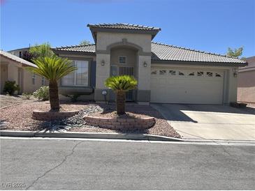 Charming single-story home featuring well-manicured landscaping and an attached two-car garage at 1617 Stonefield St, Las Vegas, NV 89144