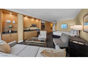 Relaxing living area with wet bar, comfortable seating, and a sleeping area in a cozy modern setting at 2000 N Fashion Show Dr # 5417, Las Vegas, NV 89109