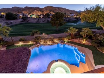 Gorgeous backyard pool and landscaping overlook golf course views and mountainous scenery at twilight at 2837 Turtle Head Peak Dr, Las Vegas, NV 89135