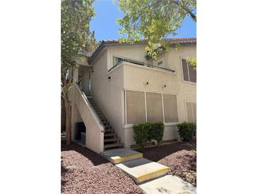 Charming condo exterior with private entry stairs and well-maintained landscaping at 3055 Key Largo Dr # 204, Las Vegas, NV 89120