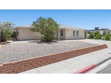 Charming single-story home features low-maintenance landscaping and a brick-lined flower bed at 321 Oil Lantern Ln, Las Vegas, NV 89145