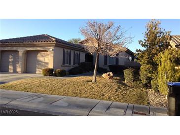 Charming single-story home with a two-car garage, well-manicured lawn, and desert landscaping at 35 Emerald Dunes Cir, Henderson, NV 89052