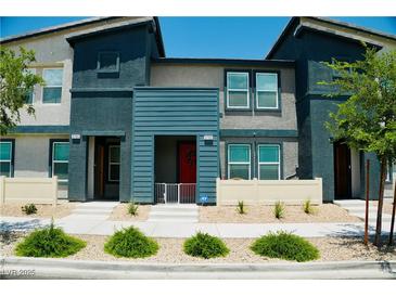 Inviting townhome featuring contemporary design and landscaping, with vibrant accents and a welcoming entrance at 3763 Sonrisa Vista Ave, Henderson, NV 89044