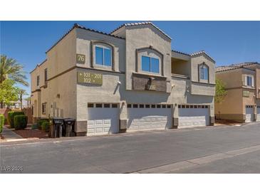 Well-maintained stucco building with individual garages in a desirable neighborhood with manicured landscaping at 3936 Pepper Thorn Ave # 3, North Las Vegas, NV 89081