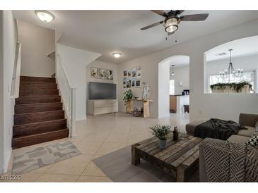 Inviting living room with wood staircase, neutral tones, and modern decor provides a comfortable space at 3936 Pepper Thorn Ave # 3, North Las Vegas, NV 89081