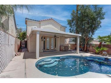 Outdoor pool and patio area offering a private retreat with a covered seating area and steps into the water at 5811 Pack Trl, Las Vegas, NV 89118