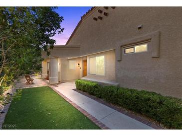 Inviting home entrance with a well-manicured lawn and path leading to the front door at 7627 Boca Raton Dr, Las Vegas, NV 89113