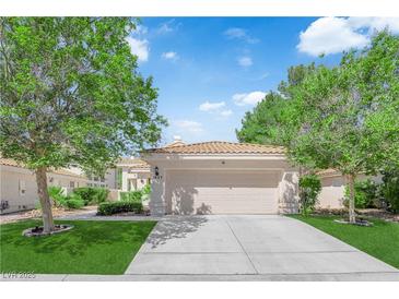 Charming single-story home featuring a tile roof, well-manicured lawn, and attached two-car garage at 7837 Sea Rock Rd, Las Vegas, NV 89128