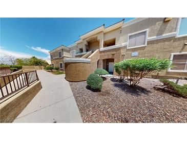 Two-story condo featuring desert landscaping and a private entrance, blending style and low-maintenance living at 8070 W Russell Rd # 1046, Las Vegas, NV 89113
