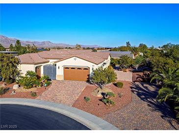 Inviting single-story home featuring a charming facade, landscaped front yard, and a two-car garage at , Las Vegas, NV 89131