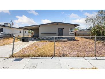 Charming single story home featuring a covered parking area and a chain link fence at 104 Stanford St, Las Vegas, NV 89107