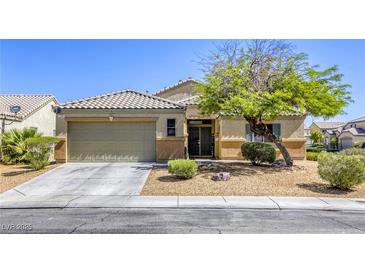 Charming single-story home featuring a xeriscaped front yard and two-car garage at 1208 Neva Ranch Ave, North Las Vegas, NV 89081