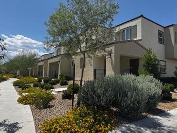 Inviting home exterior with attractive landscaping and manicured bushes under a sunny sky at 3493 Arcadian King Ave, Las Vegas, NV 89106