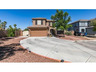 Two-story home features a circular driveway, two-car garage and desert landscaping at 4512 Long Horse Ct, Las Vegas, NV 89147
