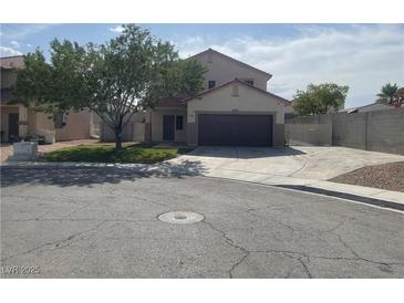 Charming two-story home featuring a well-manicured lawn and an extended driveway at 6043 Cape Clairmont Ct, North Las Vegas, NV 89031