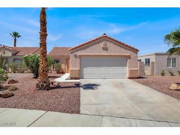 Charming single-story home with a two-car garage and desert landscaping in a sunny neighborhood at 612 Moontide Ct, Henderson, NV 89011