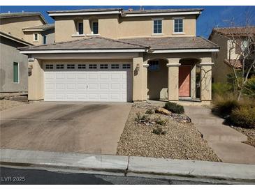 Two-story home featuring a two car garage, desert landscaping, and covered entryway at 9022 Sosa Creek Ave, Las Vegas, NV 89149