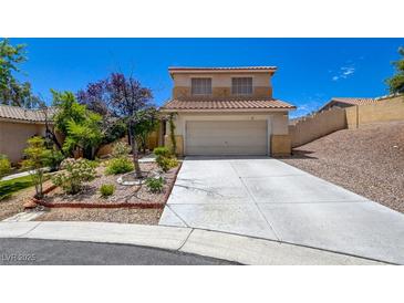 Charming two-story home featuring a well-maintained yard with mature landscaping, a concrete driveway, and an attached two-car garage at 10645 Lace Vine Arbor Ave, Las Vegas, NV 89144