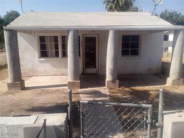 Charming front exterior featuring unique column supports, a small front porch, and gated yard access at 192 W Alma Ave, Overton, NV 89040